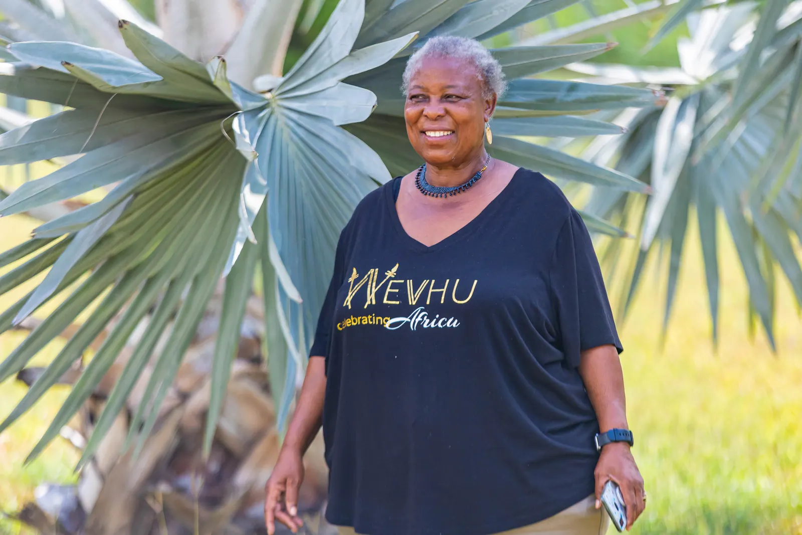 A delegate smiling in the garden of the University of Dar es Salaam Library