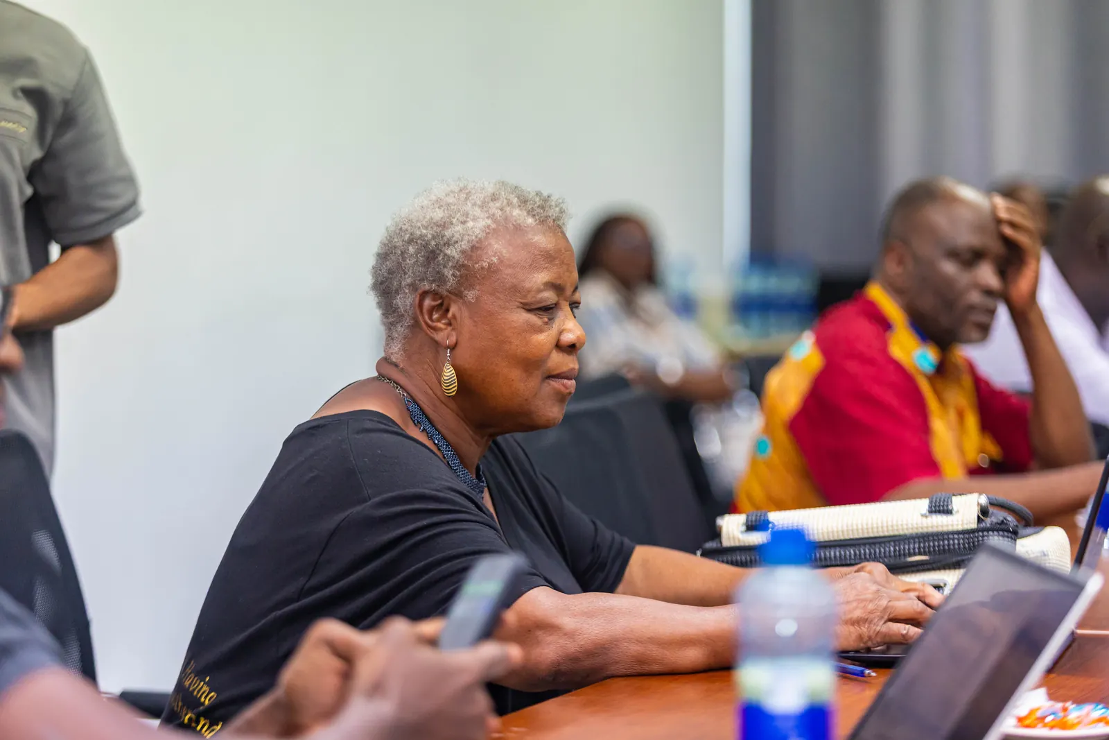 A delegate taking notes on her laptop during a session